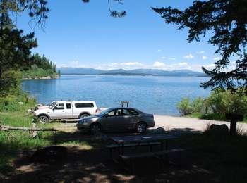 Spalding Bay area with vehicles parked and Jackson Lake beyond