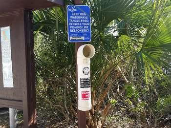 This is a photo of the recycle tubes for discarded fishing line to protect birds, turtles, and other wildlife from getting tangled in fishing line left behind by careless anglers.
