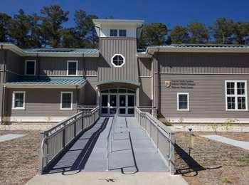 Accessible ramp leading to the double-door entrance of the visitor center