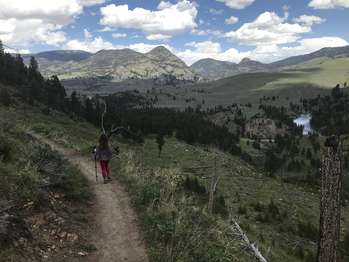 A young girl hikes down the trail with enjoying the views of the Yellowstone River valley.