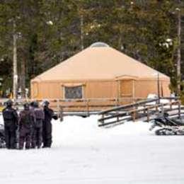 Tan warming yurt with a light snow