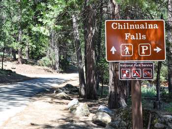 A brown and white roadside sign reads,