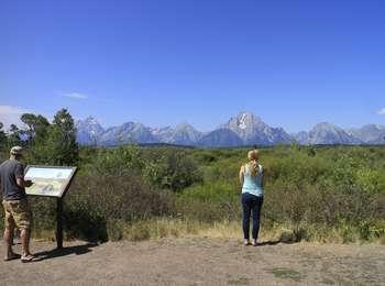 Visitors at the Upper Willow Flats Overlook with a view across the flats toward the northern Teton Range