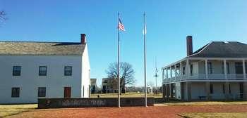 brick walkways with two flags and a stone wall