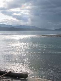 A shore with sun breaking through after a rain shower.