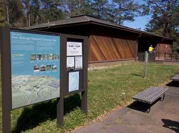 Orientation-style exhibit with a map of the grounds and park information stands near the visitor center
