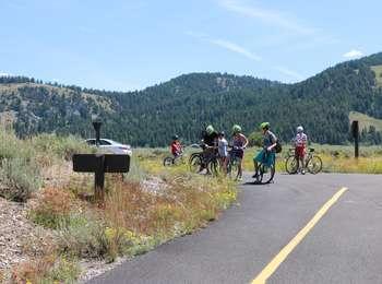 Bicyclists on the multi-use pathway at the junction of Dornans access road and the Teton Park Road