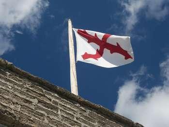 red and white cross of burgundy flag flies over fort matanzas