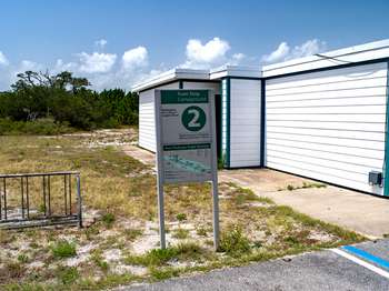 Metal sign with green and white text and the number, 