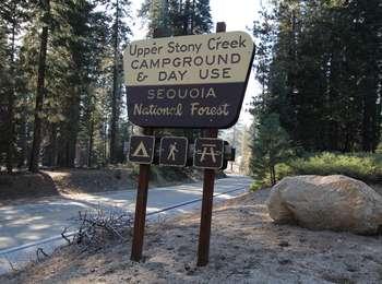 A brown and yellow road sign indicating the location of a campground.