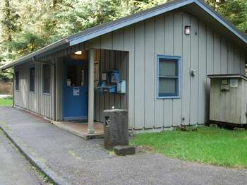 A one-story beige building with a sign that says 