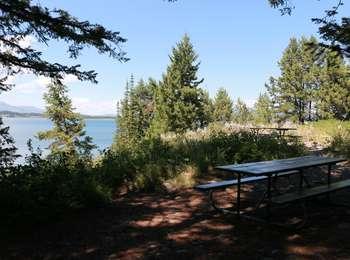 Shaded picnic table at Catholic Bay looking out over Jackson Lake