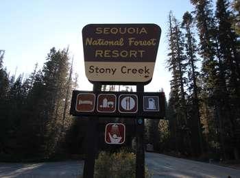 A brown and yellow road sign indicating a resort location.