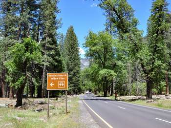 A brown and white roadside sign reads, 