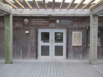 Two doors at the entrance to the wooden Hatteras Island Visitor Center.