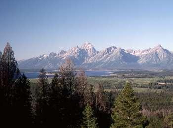 View of central Teton Range from Grandview Point with Jackson Lake visible on valley floor.