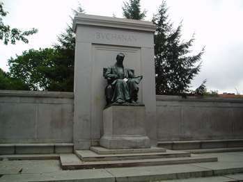 A bronze seated statue of President Buchanan. The platform is granite, with two figures representing Law and Diplomacy. 