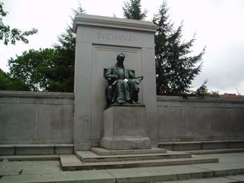 A bronze seated statue of President Buchanan. The platform is granite, with two figures representing Law and Diplomacy.