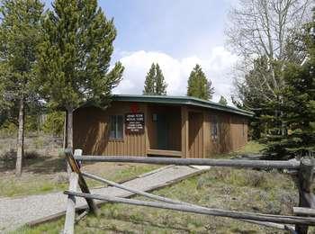 Grand Teton Medical Clinic at Jackson Lake Lodge with buck and rail fence in front of tan building with green trim