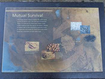 A wayside exhibit stands along a roadside pullout.