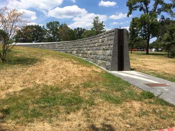 A brick levy divides a large patch of grass