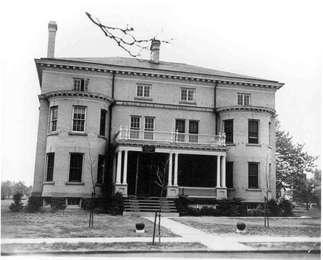 A black and white photograph shows the elegant three story building that housed unmarried officers at the base.