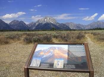 Wayside sign for Mount Moran Turnout with sagebrush in foreground and Mount Moran in background.