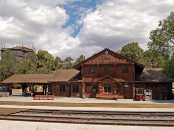 Wooden Train Depot in front of train tracks