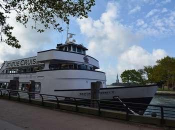 The triple decker ferry is tied up at Ellis Island, ready to take on passengers for a sunny trip back to Manhattan.