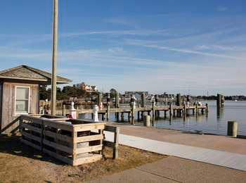 View of the harbor and docks, with part of the village visible in the background, across the harbor.