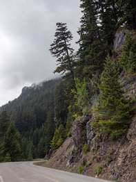 A road cut into a steep rocky mountainside.