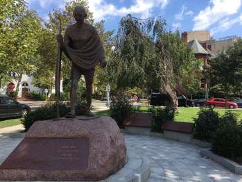 A stone statue of Gandhi