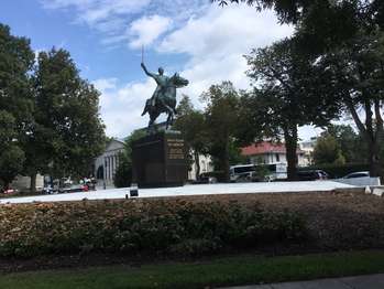 A statue of General Simon Bolivar riding a horse and holding up a sword 