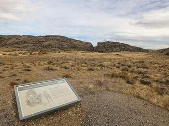 Distant view of Martin's Cove Visitor Center building complex with Devil's Gate in the background