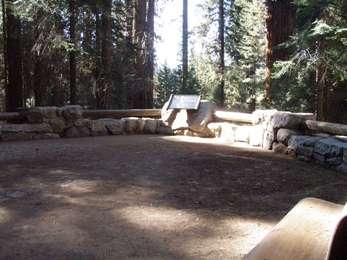 Wayside exhibit mounted on level rest place in forested area