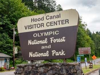 A sign reads "Hood Canal Visitor Center, Olympic National Forest and National Park"
