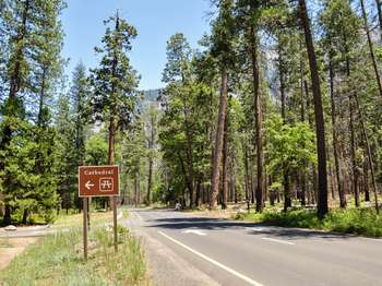 A roadside sign reads,