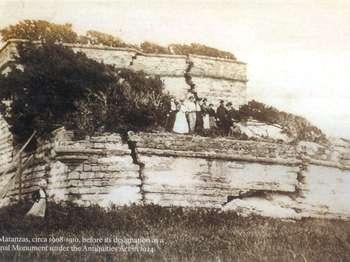 a group of people dressed in early 20th century clothing stand atop the crumbling matanzas watchtower