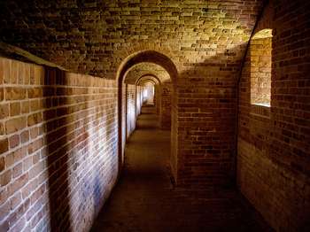 Brick tunnel with a series of brick arches and loopholes.