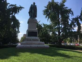 A statue of Daniel Webster standing on a pedestal