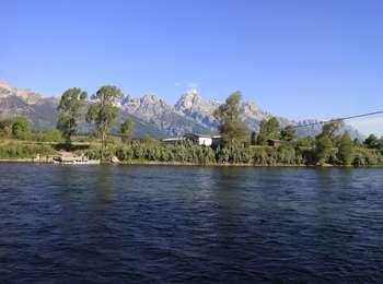 Looking across the Snake River toward the cabins of Bill Menors homestead with the Teton Range beyond.