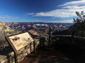 Lookout Studio on the edge of the canyon with wayside about the building and blue sunny sky