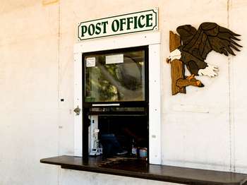 A small service window has a sign above it that reads,