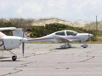 A couple of airplanes sit on the tarmac of the Billy Mitchell Airstrip