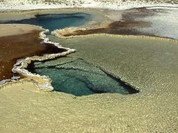 Close-up of the white rim around both pools, as well as the deep vents far below the surface.