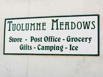 A white sign with green lettering reads