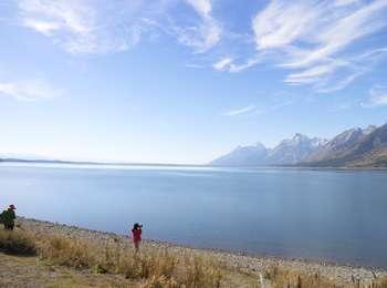 Visitors at the north end of Jackson Lake looking south along the Teton Range