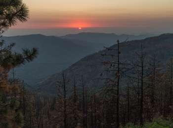 Sunset over hazy mountain ridges