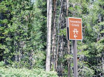 A brown and white roadside sign reads, 