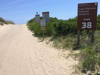 Sign marking ramp 38 and the ORV driving rules are seen to the right of the sand ramp leading over the dunes